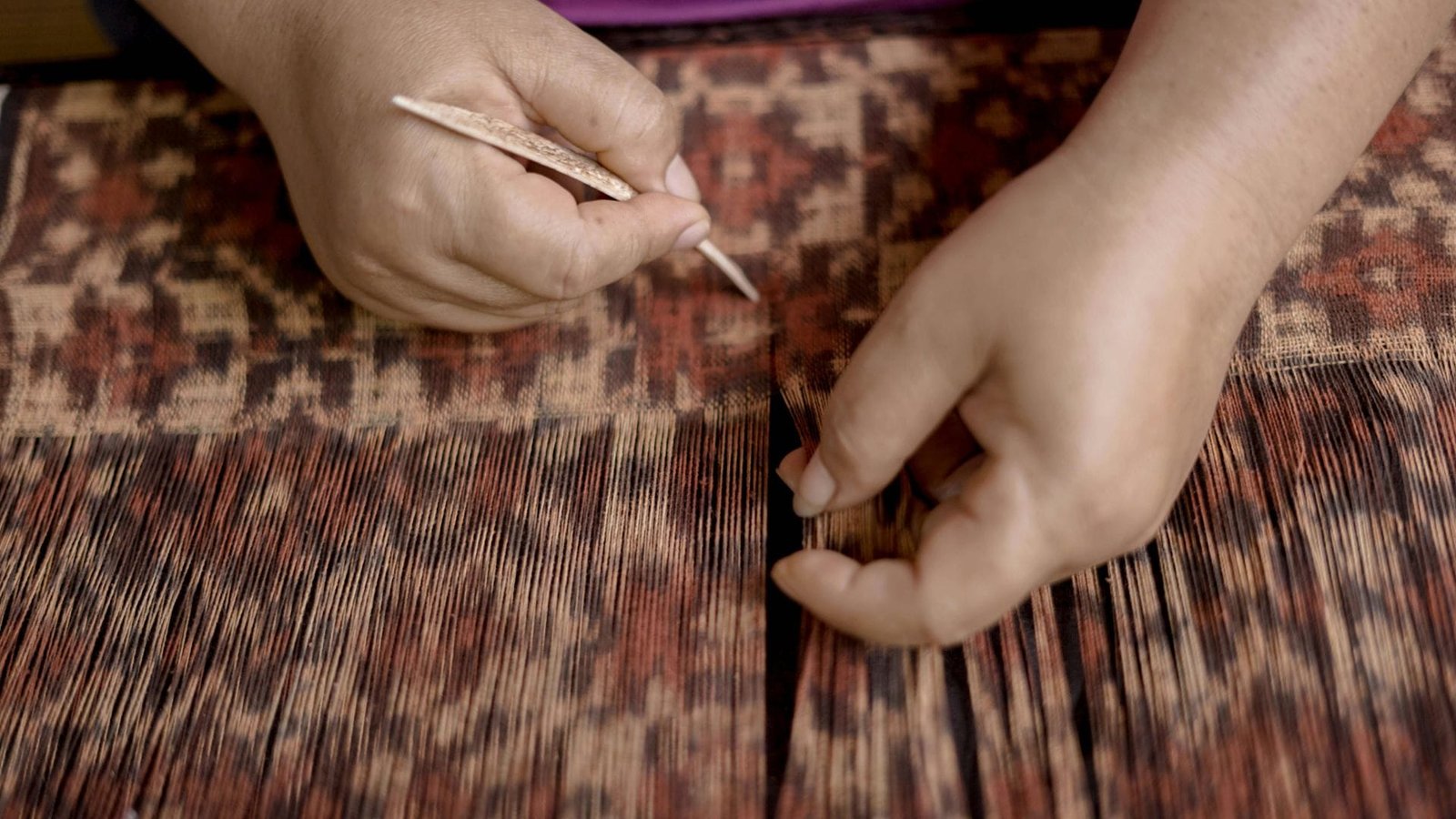 Authentic Bali experiences with an artisan weaving traditional ikat textiles by hand